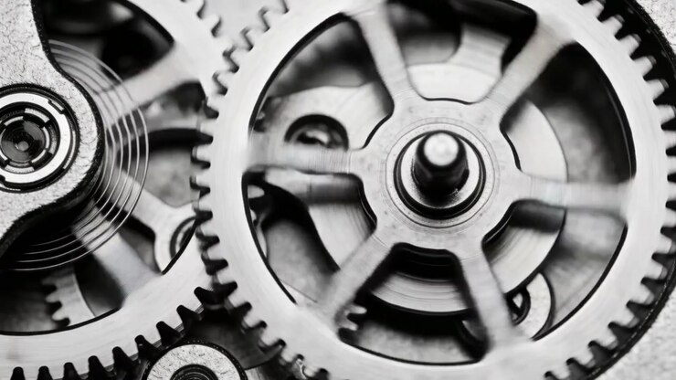 Engaging power, large spoked gear turning in gearbox, pinion meshing, spring moving, sending power