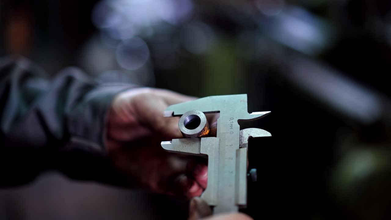 Worker measures the detail. Worker measuring detail with vernier caliper at workshop