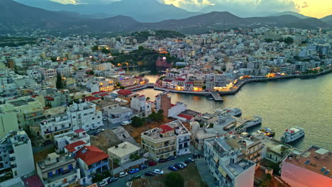 scenic aerial view of a coastal town and harbor at dusk