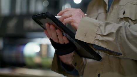 man using a tablet with a stylus