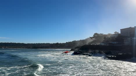 4k 영상 드론이 대양 물결 위를 날아다니며 산 디에고의 la jolla cove에서 조류가 상승하는 동안 절벽에 부히고 있습니다.