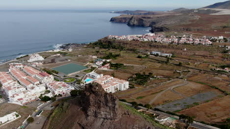 aerial-shot-over-the-port-of-the-Agaete-valley,-appreciating-the-ocean