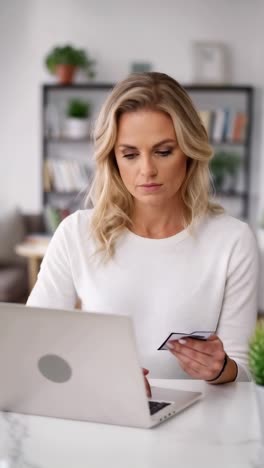 woman using laptop and credit card for online shopping