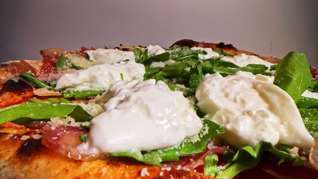 Close-up of a delicious pizza with fresh arugula and creamy burrata