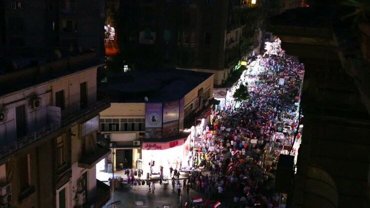 Overhead view of a large nighttime protest rally in the stets of Cairo Egypt