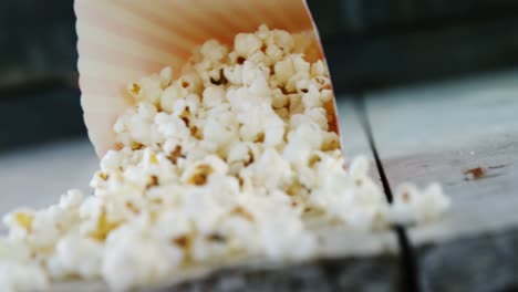 Popcorns-spilled-on-wooden-table