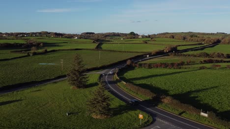 aerial view descending to vehicles restriction to 20 miles per hour speed limit in rural farming countryside