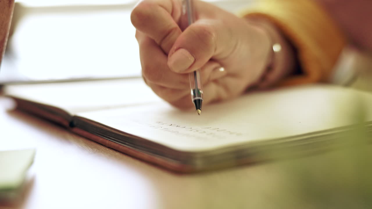 Woman, hand and pen writing in a notebook at home
