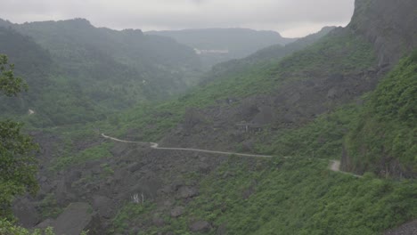 the vehicle is passing through a once collapsed mountain road