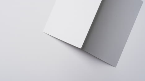 Video-of-book-with-white-blank-cover-pages-and-copy-space-on-white-background