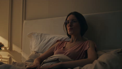 smiling woman finishing work in night bed. happy girl resting closing computer