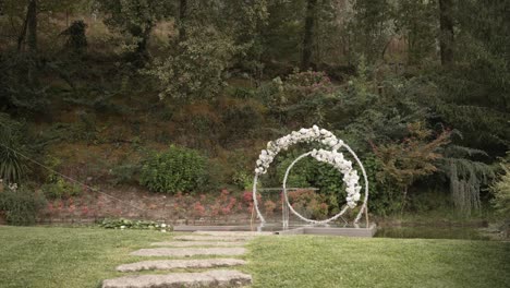 floral wedding arch in a lush garden setting, ready for an outdoor ceremony