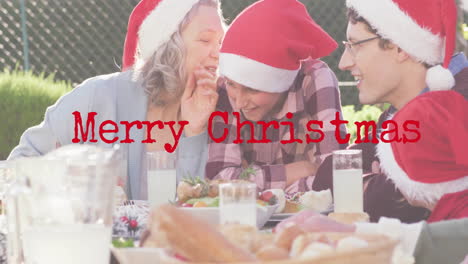 animation of christmas greetings text over caucasian family in santa hats at christmas table