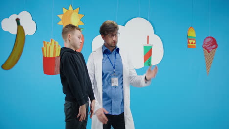 doctor discussing healthy food choices with a boy