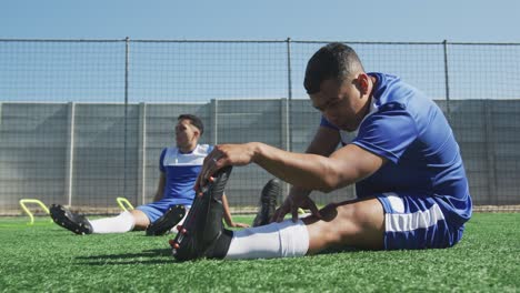 Jugadores-De-Fútbol-Estirándose-En-El-Campo