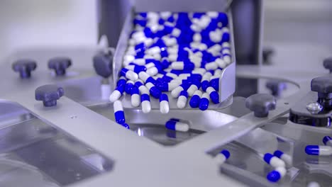 pills for coronavirus treatment falling into a spinning plate during its mass production