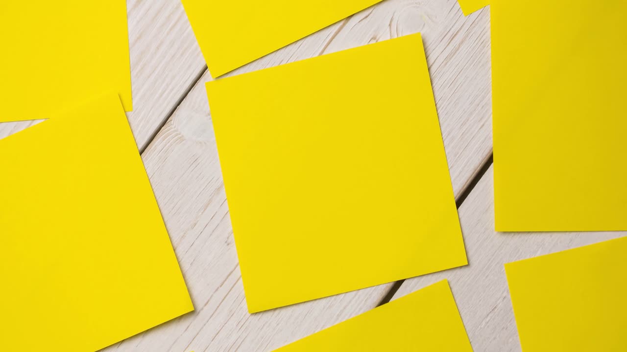 Animation of multiple yellow cards lying on wooden table