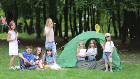 Happy Kids at the Picnic Near the fire Children in the Camp by the Bonfire Group Teen Outdoors at Summer