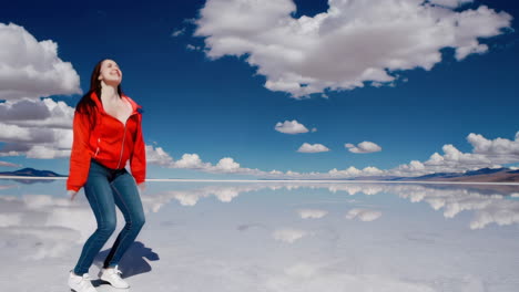 joyful woman jumping on reflective salt flats under a blue sky