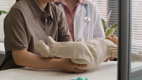 doctor examining a baby during a medical checkup