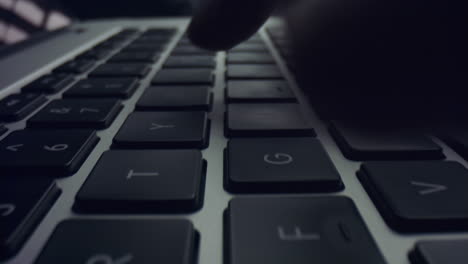 Man-hand-working-on-laptop-computer.-Male-fingers-typing-buttons-on-laptop