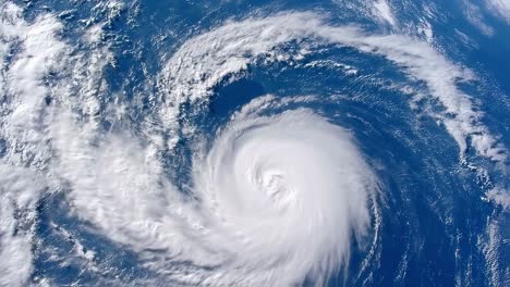 a powerful hurricane is swirling in the ocean, vividly captured from a satellite's perspective over the vast atlantic waters