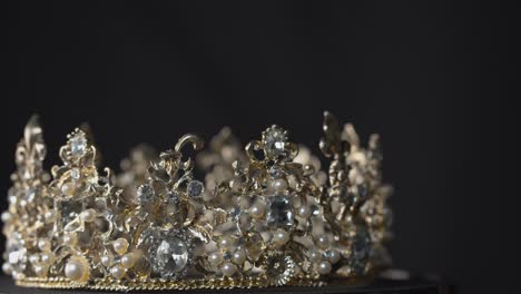 crown of diamonds, pearls and silver on a turntable stand display spins in glorious beauty - for queen, bride or pageant winner