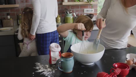 Mother-and-son-preparing-cookie-on-worktop-in-kitchen-at-home-4k