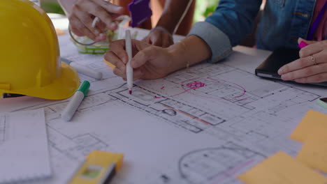 close up hands architects using building plans business women working together on construction project team of engineers brainstorming design solution planning successful development strategy