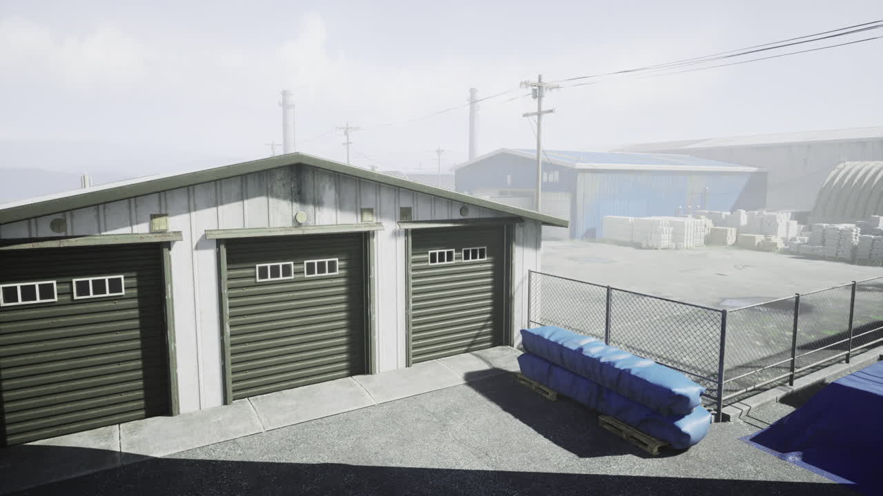 Industrial storage area with multiple garages and warehouses in foggy weather