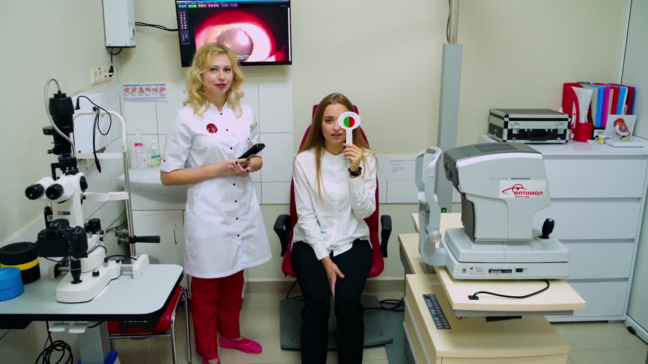 Ophthalmologist checking eye vision. Young woman having eyes examined by ophthalmologist