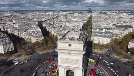 drone footage around the arc de triomphe overlooking the center of paris.