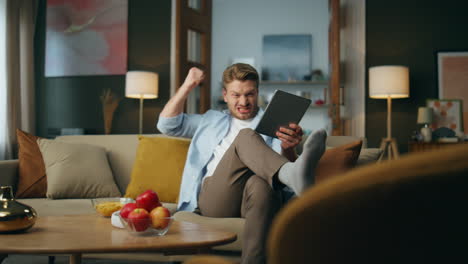 excited guy winning gesturing evening interior. emotional man winner achieving