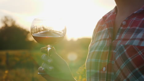 woman holding red wine