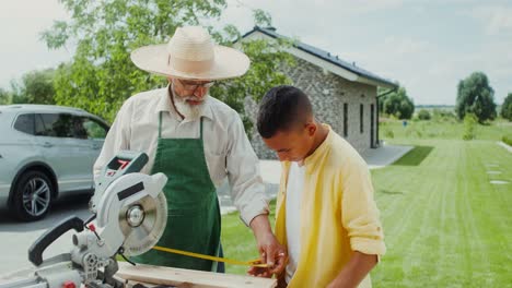 grandfather teaching grandson woodworking