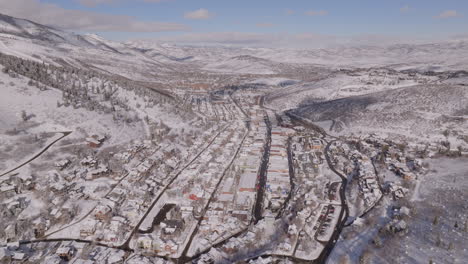 Beautiful-Aerial-Drone-Shot-Pushing-Into-Park-City,-Utah,-on-a-Sunny-Day-in-Winter,-4K