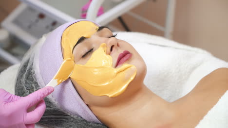 young woman gets beauty facial injections in salon. aesthetic cosmetology. application of face mask in the spa.