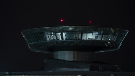 Time-lapse-of-airport-control-tower-with-red-lights-at-night