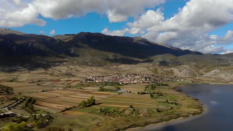 countryside panoramic view with villages on shore of mountain lake in prespa, albania