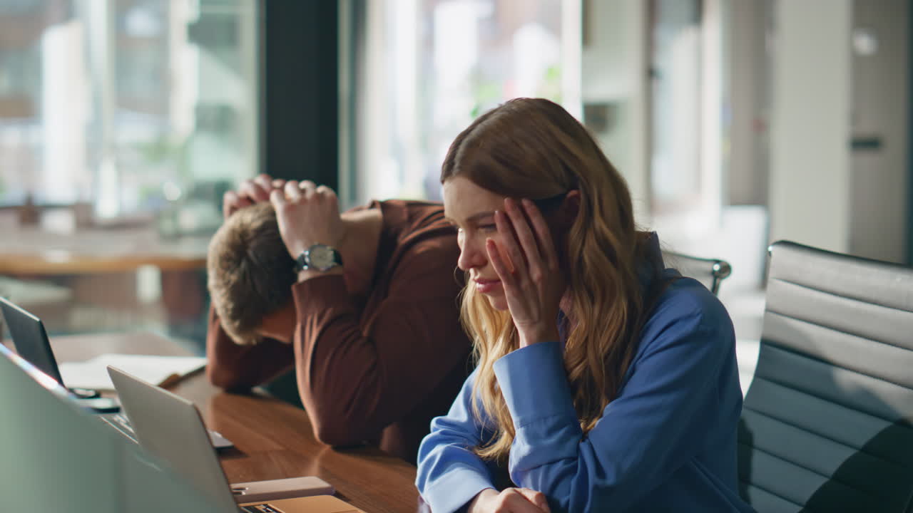 Sad colleagues disappointed failure business project at office desk ...