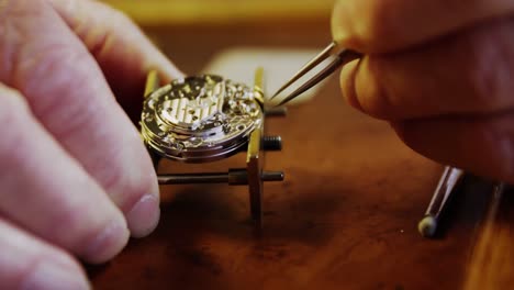 close-up of horologist hands repairing a watch