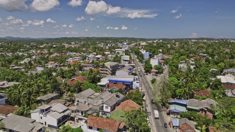 matara sri lanka aerial v5 establishing shot drone flyover along b535 highway nilwala bypass through nupe town area capturing local townscape on a sunny day - shot with mavic 3 cine - april 2023