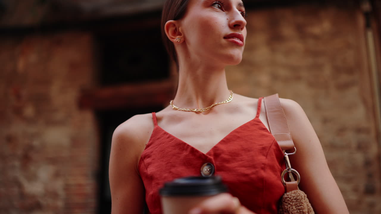 Stylish woman in red dress on city street