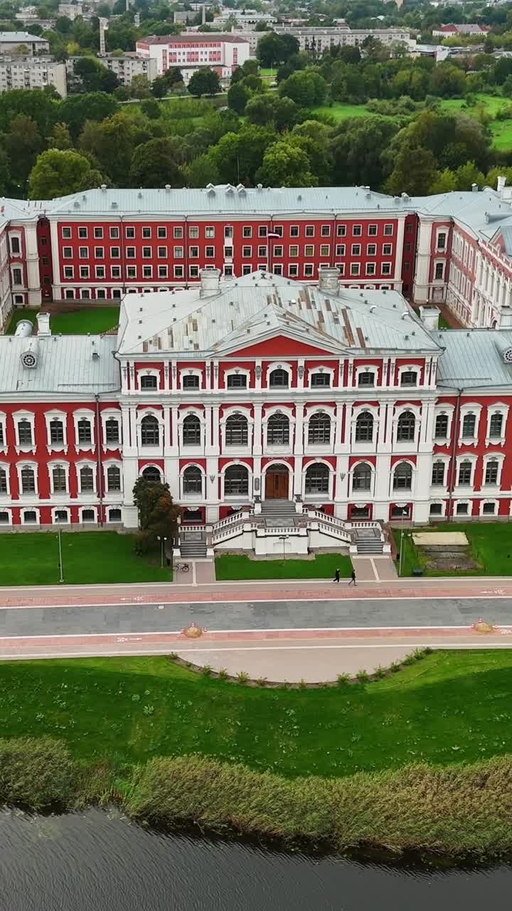 Aerial view of Jelgava Palace, vibrant exterior, Latvia, in lush scenery