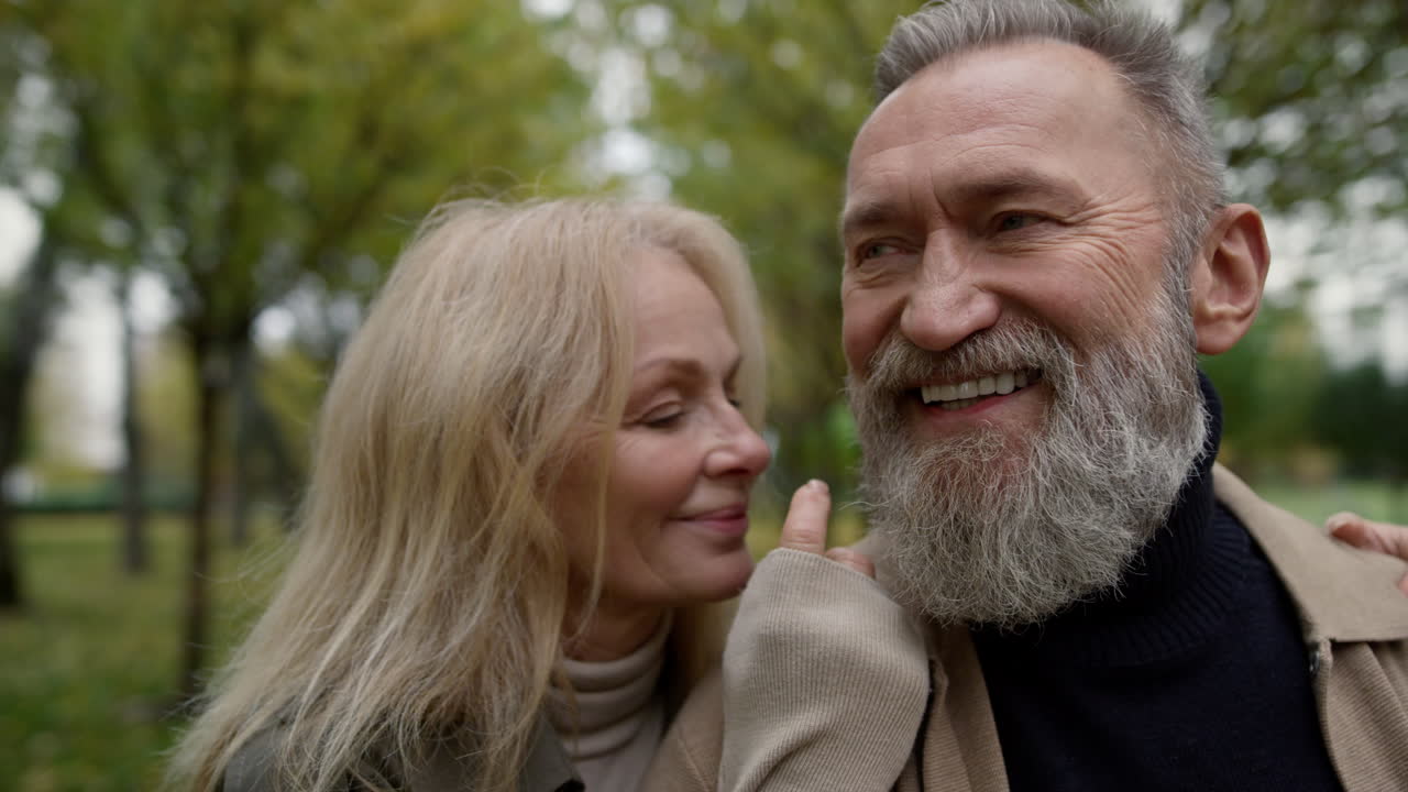 Close up portrait of married couple having fun outdoors. Smiling aged man .