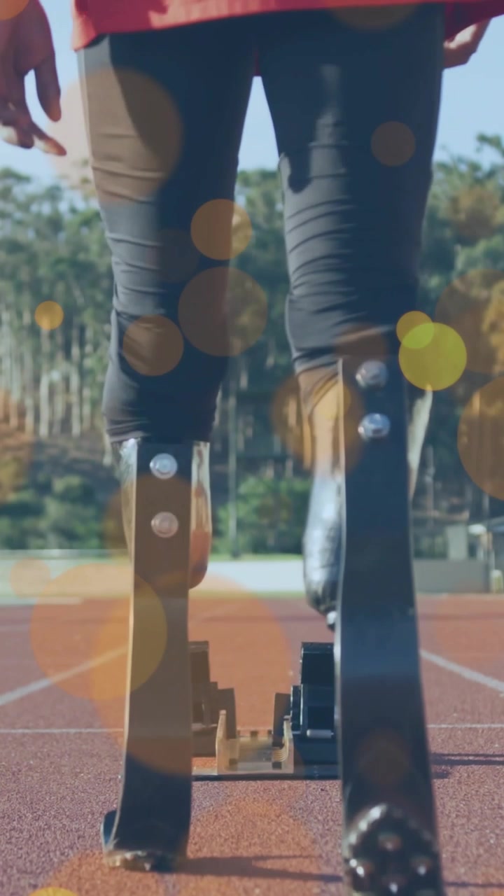 Vertical video: Teen athlete stepping aligning carbon blades into block with bokeh preparing sprint