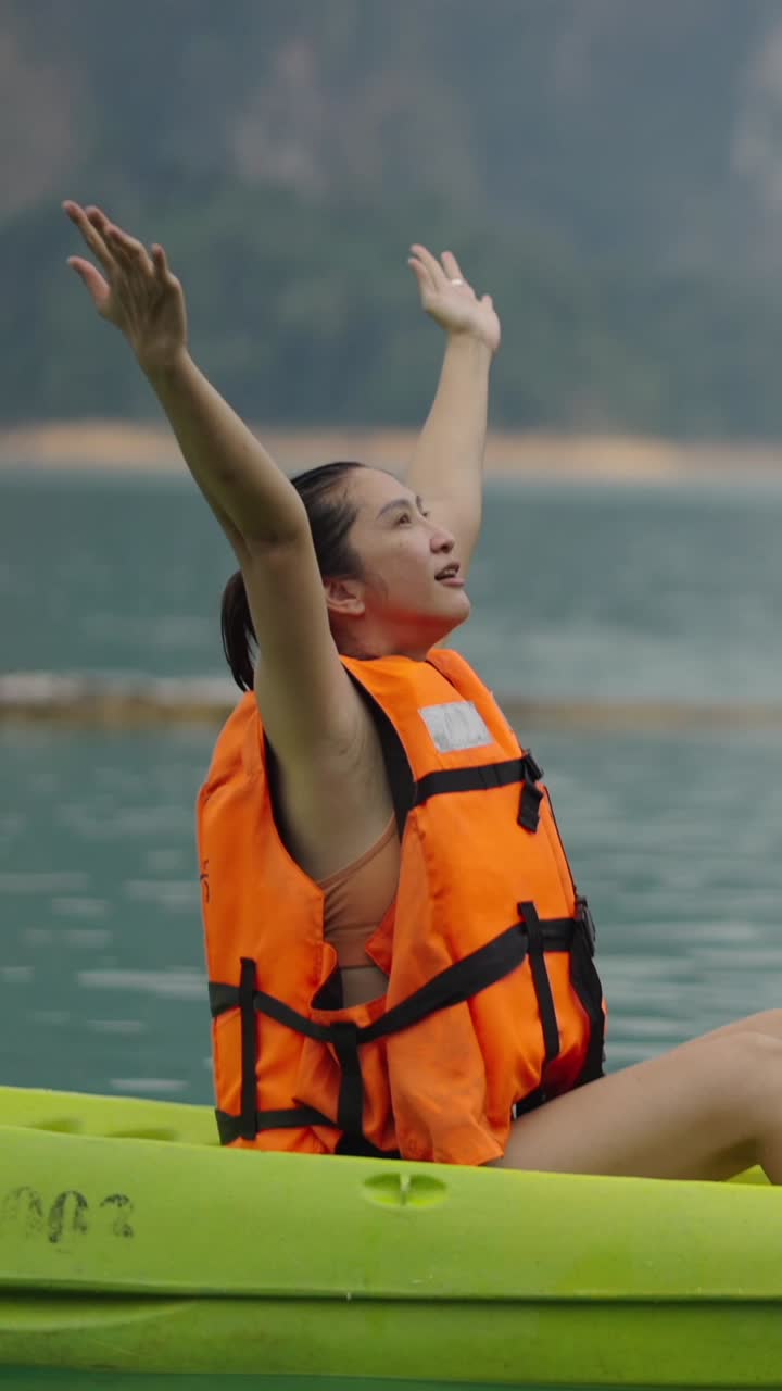 Woman celebrating on a kayak