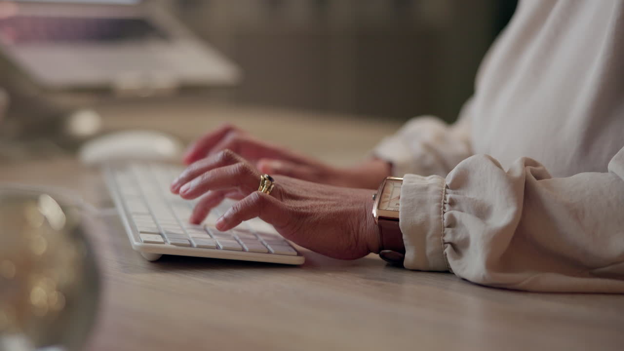 Hands typing on a keyboard