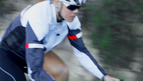 female cyclist cycling on a countryside road 4k