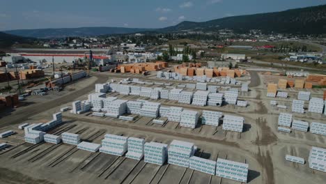 lumber stored and stacked in lumber yard outside sawmill